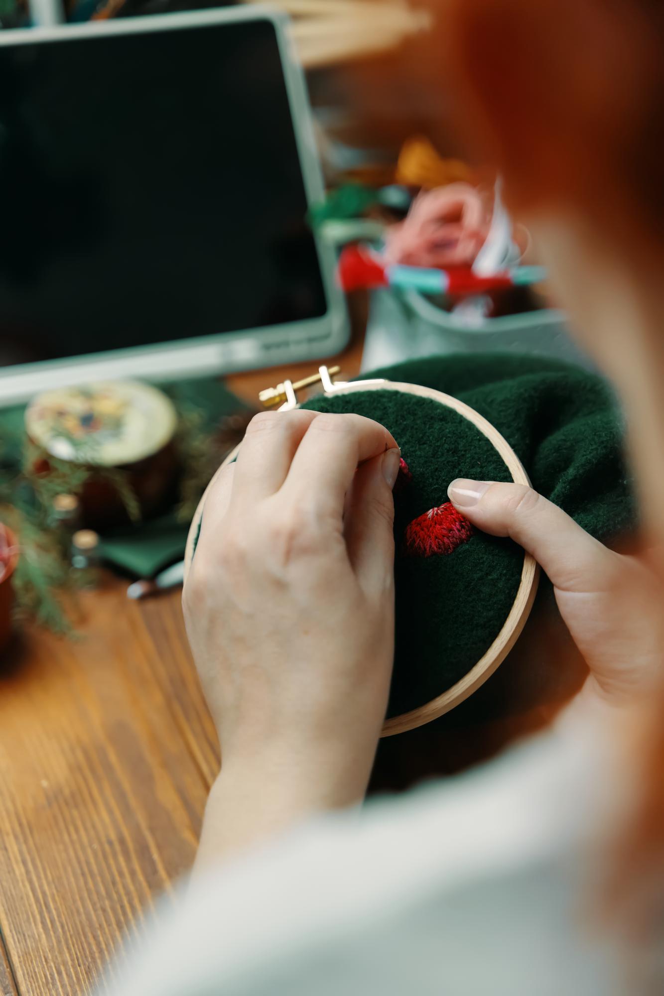 Studio hands at work with needle and hoop